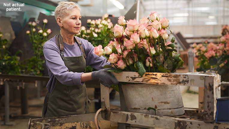 Woman arranging flowers while working at floral shop